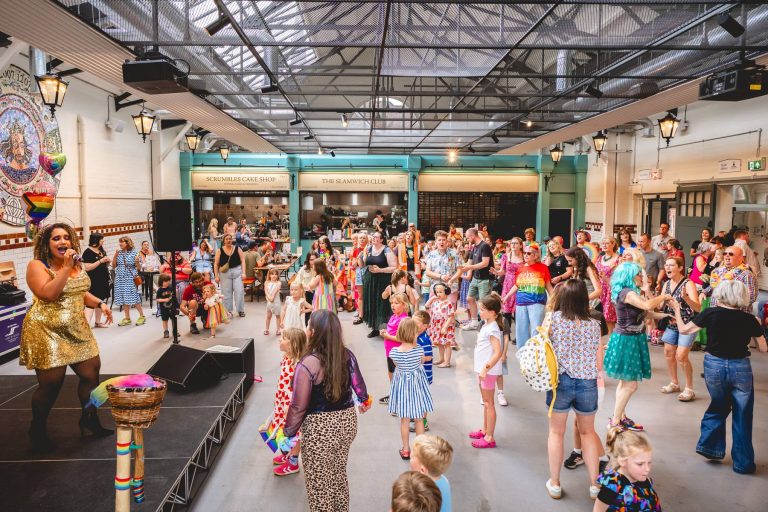 Families dance in front of the stage at Leek Indoor Market