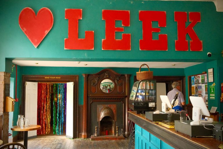 A big red "Love Leek" sign above a café counter