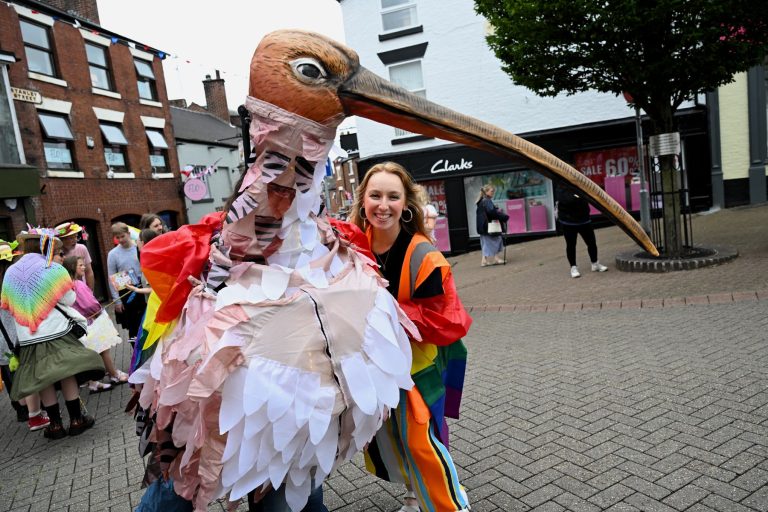 A giant curlew puppet makes its way through the crowd in Leek
